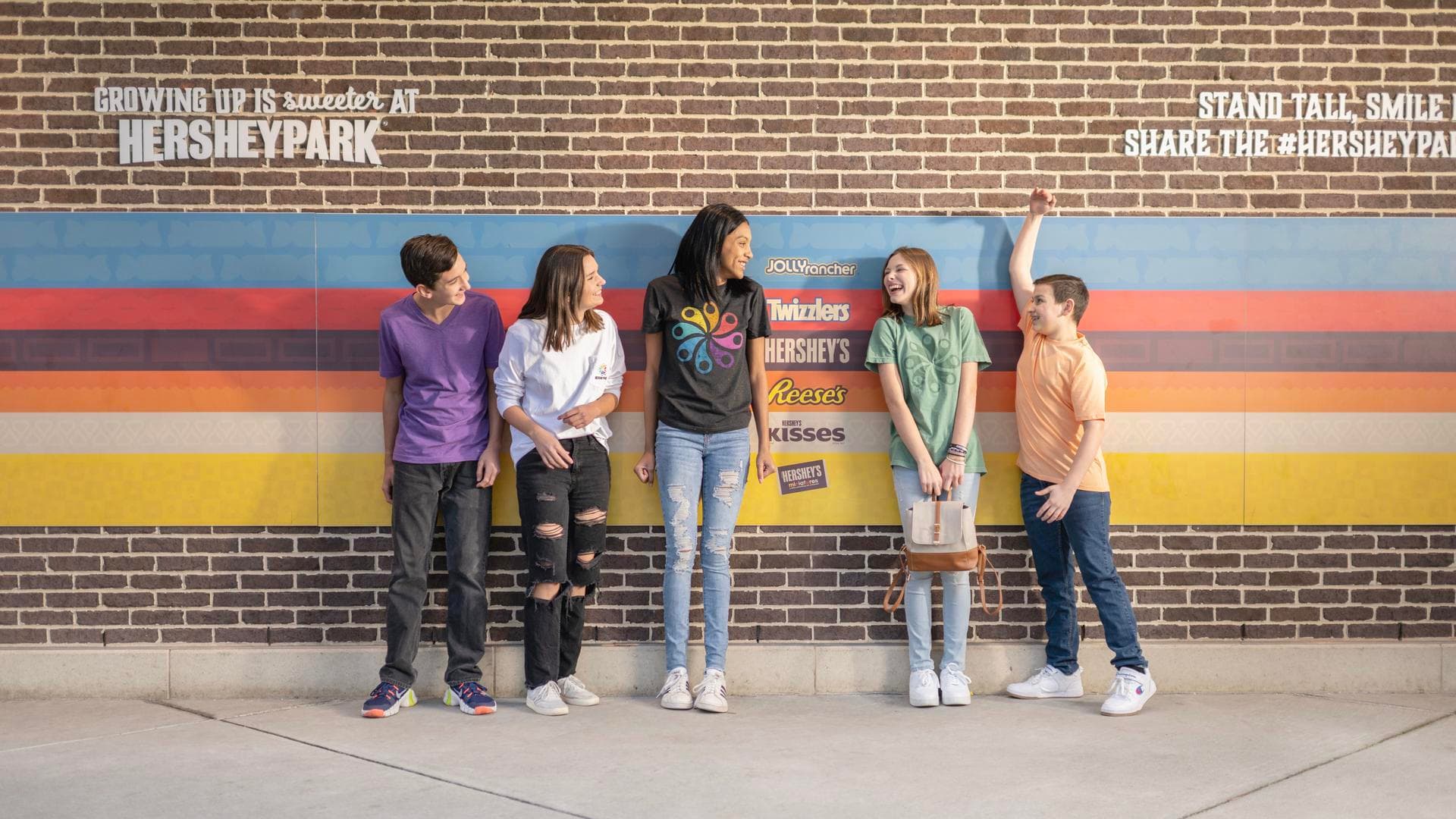 group of students in front of height chart wall at hersheypark