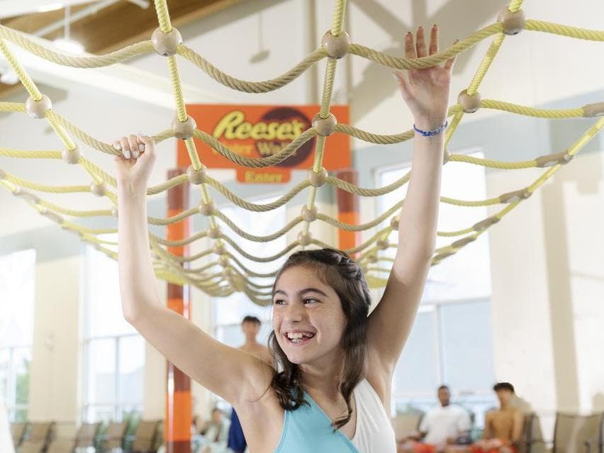 girl playing on ropes course at hershey water works
