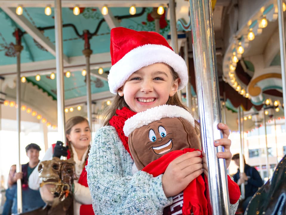 Girl Riding Carrousel At Christmas